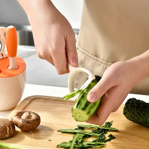 Ergonomic white vegetable peeler for cucumber and potato, kitchen tool set component.