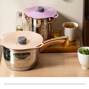 Detailed view of heat-resistant pink and purple silicone lids on stainless steel pots.