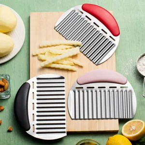 Stainless steel wave cutter set for potatoes and vegetables on wooden board.