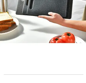 Detailed shot of three black plastic cutting boards with granite texture in a kitchen setting