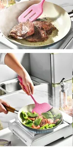 Action shot of pink silicone spatula and slotted turner cooking meat and vegetables