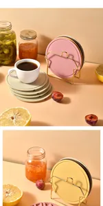 Detailed view of colorful silicone heat insulation mats with a gold metal stand holder.