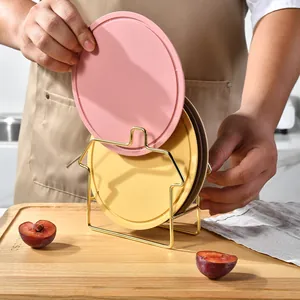 Set of colorful silicone heat insulation mats with a decorative gold storage rack
