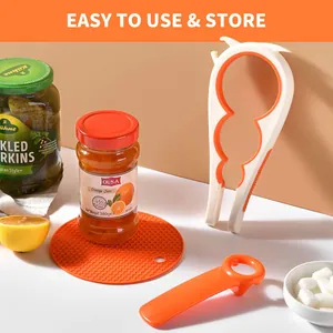 Multifunctional jar and bottle opener set with orange silicone honeycomb mat.