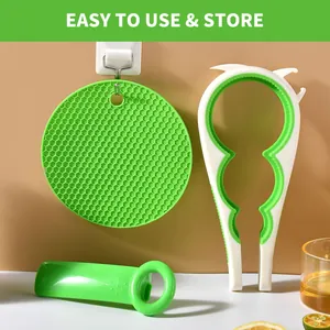 Multifunctional jar opener set and silicone mat shown hung on a wall for easy storage