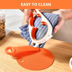 Cleaning the multi-functional jar opener tool with a striped cloth in a kitchen