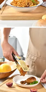 Close-up of heat-resistant silicone food tongs picking up a roasted chicken leg
