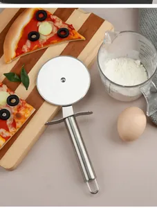 Close-up of stainless steel pizza cutter wheel shown in a kitchen baking setting
