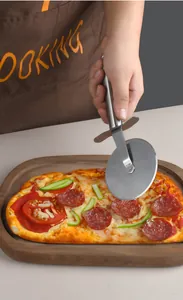 Action shot of stainless steel pizza cutter slicing through a pepperoni pizza