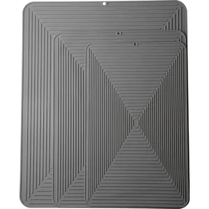 Three-piece set of gray rectangular silicone dish drying mats with non-slip drainage ridges