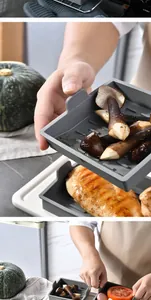 Detailed view of grey square silicone baking tray with grilled mushrooms and meat.