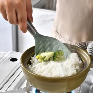 Spatule à riz en silicone avec manche en inox dans une scène de cuisine avec du riz
