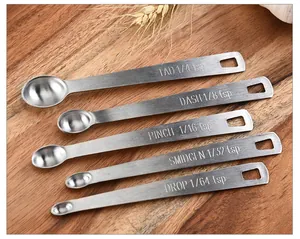 Close-up of five stainless steel mini measuring spoons with engraved fractional tsp sizes
