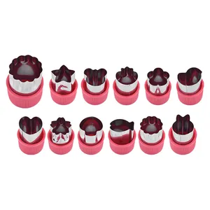 12-piece stainless steel cookie and vegetable cutter set with pink protective hand guards.