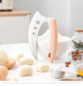 Curved stainless steel dough cutter with ergonomic peach handle in a baking scene.