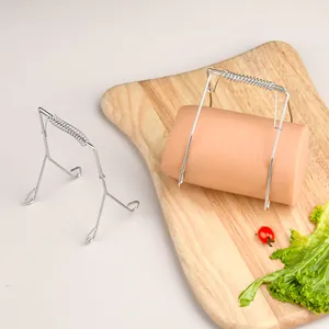 304 stainless steel spring clip for frying sausage and meat rolls on a cutting board