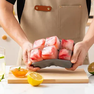 6-cell large silicone ice cube tray with fresh strawberry ice cubes held by hands