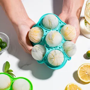 Turquoise 7-hole silicone round ice ball mold with frozen fruit slices for whiskey drinks