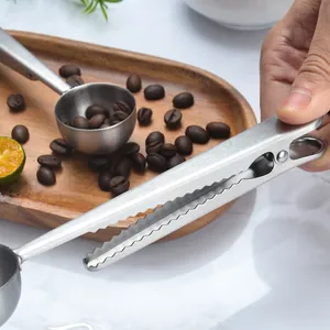 Stainless steel coffee scoop with integrated bag sealing clip and crocodile teeth design