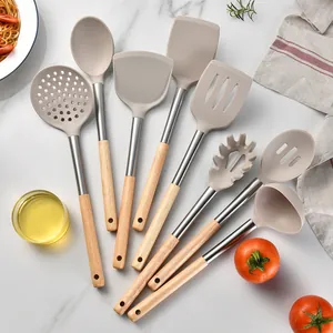 Premium silicone kitchen utensil set with oak wood handles displayed on marble surface.