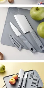 Grey kitchen knife set with cutting board shown alongside fresh green and red apples