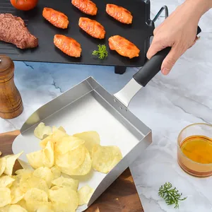 Large stainless steel food shovel for scooping french fries and snacks in a kitchen setting
