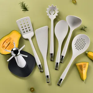 7-piece white silicone kitchen utensil set with storage stand and elegant metallic accents