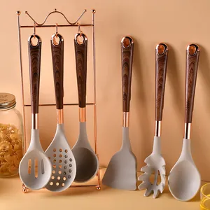 7-piece silicone kitchen utensil set with rose gold stand and wood-grain handles