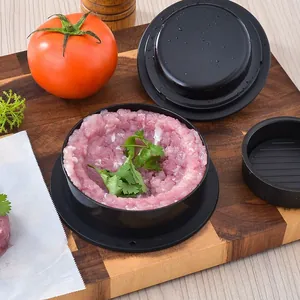 Circular plastic burger press patty maker kit shown with meat on a wooden cutting board