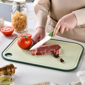 Eco-friendly wheat straw double-sided cutting board with garlic grinder in kitchen setting