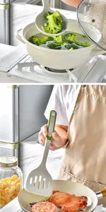 Close-up view of white heat-resistant silicone slotted spoon and spatula being used