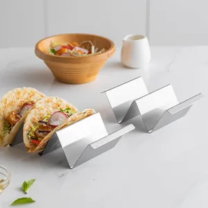 W-shaped stainless steel taco holder rack displaying prepared tacos on marble surface