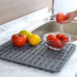 Grey silicone dish drying mat for kitchen countertop and sink protection.