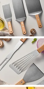 Detailed view of professional stainless steel Teppanyaki spatula and fork set with wood handles