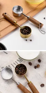 Detailed view of gold and silver stainless steel measuring spoons with natural wood handles