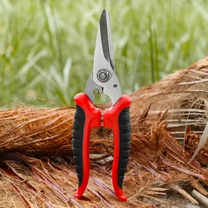 Cesoie professionali da giardino con impugnature ergonomiche rosse e nere su sfondo naturale