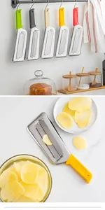 Detail view of a stainless steel vegetable slicer with a yellow handle slicing potatoes