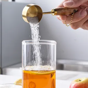 Gold plated stainless steel 14ml measuring spoon with an ergonomic wooden handle