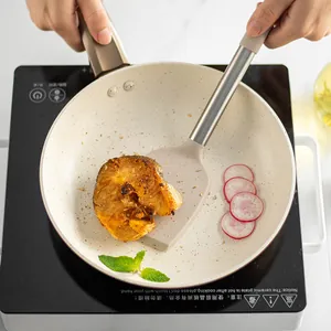 Silicone spatula with 430 stainless steel handle being used in a non-stick frying pan