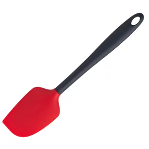 Flexible red silicone baking spatula with ergonomic black handle for cream cake mixing
