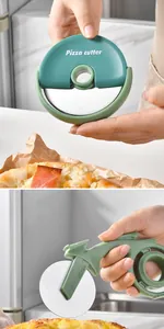 Close-up of a stainless steel pizza cutter wheel and an ergonomic slicer in use