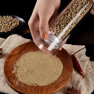 Clear acrylic pepper grinder with manual grinding mechanism for kitchen spices.