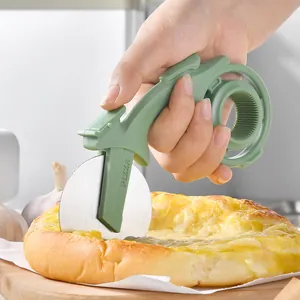 Ergonomic green handle pizza cutter wheel with stainless steel blade slicing fresh pizza