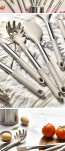 Detail shot of silicone kitchen utensil set with stainless steel handles on cloth.
