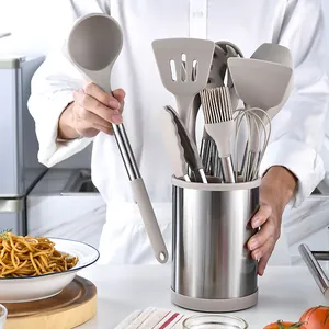 12-piece silicone and stainless steel kitchen utensil set with storage bucket shown in use