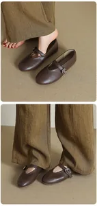 Close-up detail of retro brown leather Mary Jane ballet flats with a buckle strap