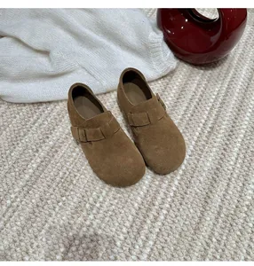 Detailed top view of brown cowhide suede Birken-style slip-on loafers with adjustable strap