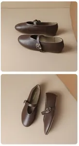 Detailed professional view of brown flat Mary Jane shoes with buckle straps and round toe