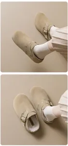 Close-up of suede clogs with soft fleece lining and adjustable buckle strap detail