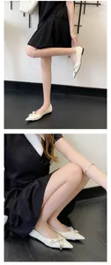 Detail showing cream French pointed-toe flats with metallic buckle on a female model.